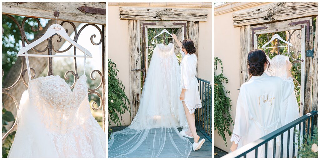 wedding dress hanging in a doorway as the bride reaches for her hanger before her wedding day at wolf lakes park