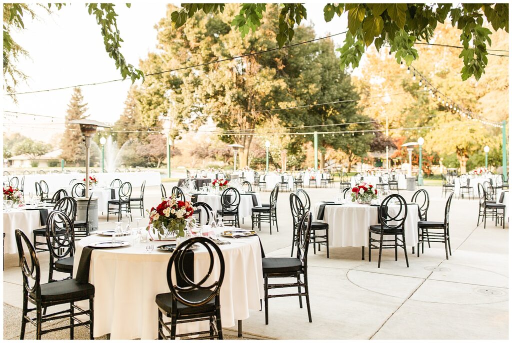 wonder valley ranch wedding reception decor set up, white table clothes with black chairs