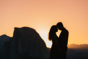 Silhouette of a couple snuggling during Sunrise