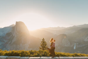 Couple dancing on the rocks at Glacier Point overlooking the sunrise at half dome