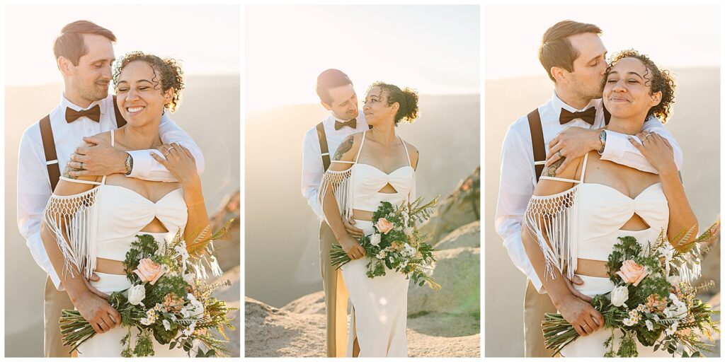 A groom embraces his bride from behind, both smiling joyfully while holding a bouquet, bathed in the golden light at Taft Point during their Yosemite elopement.