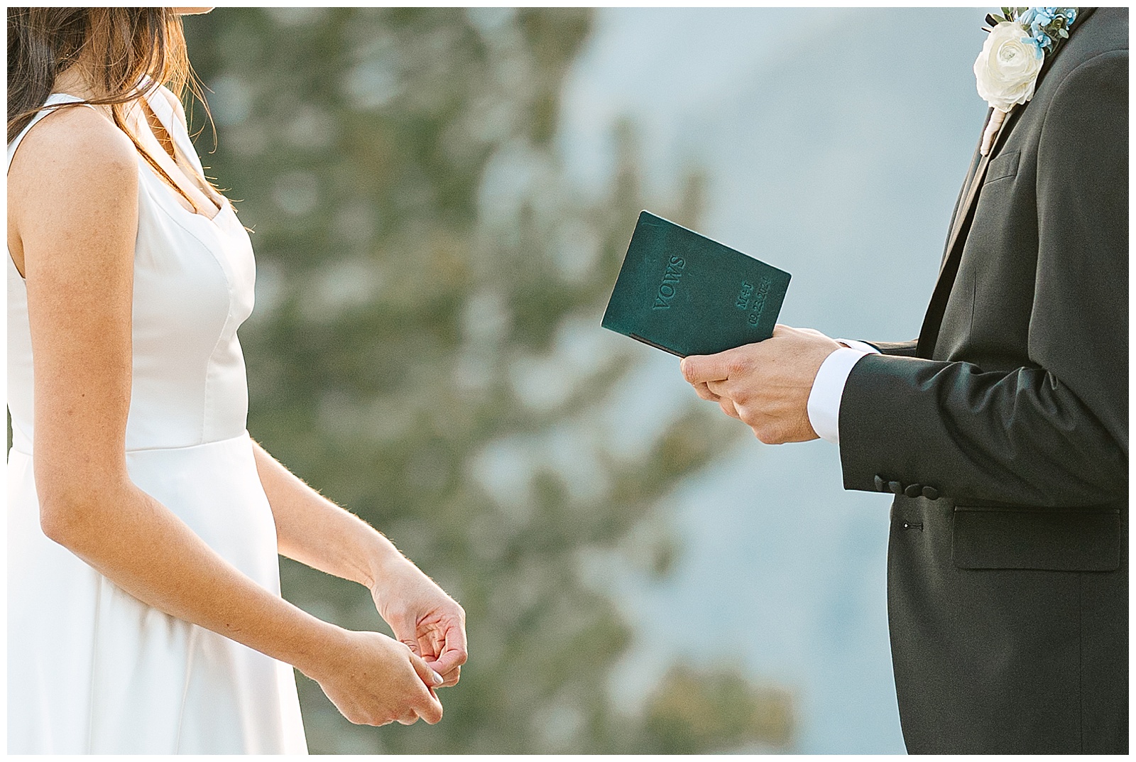 Close up of a Groom holding vow book during Yosemite Wedding Ceremony at Glacier Point